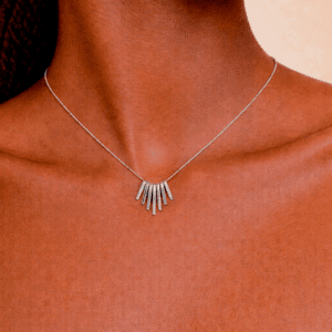 Close-up of a silver minimalist fan pendant necklace