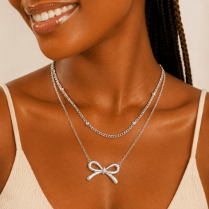 Stainless steel layered bow pendant necklace available in gold and silver