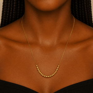 Gold stainless steel necklace with polished bead accents